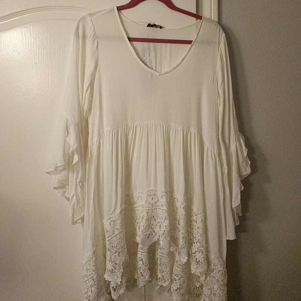 White flowy bell sleeved top